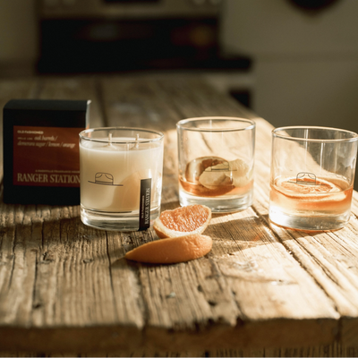 Three glasses with different liquids on a wooden surface, with a box labeled 'Ranger Station' in the background.