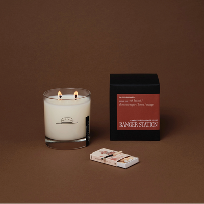 Candle with packaging on a brown background